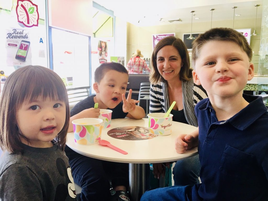 Photo of adults and kids sitting at a table